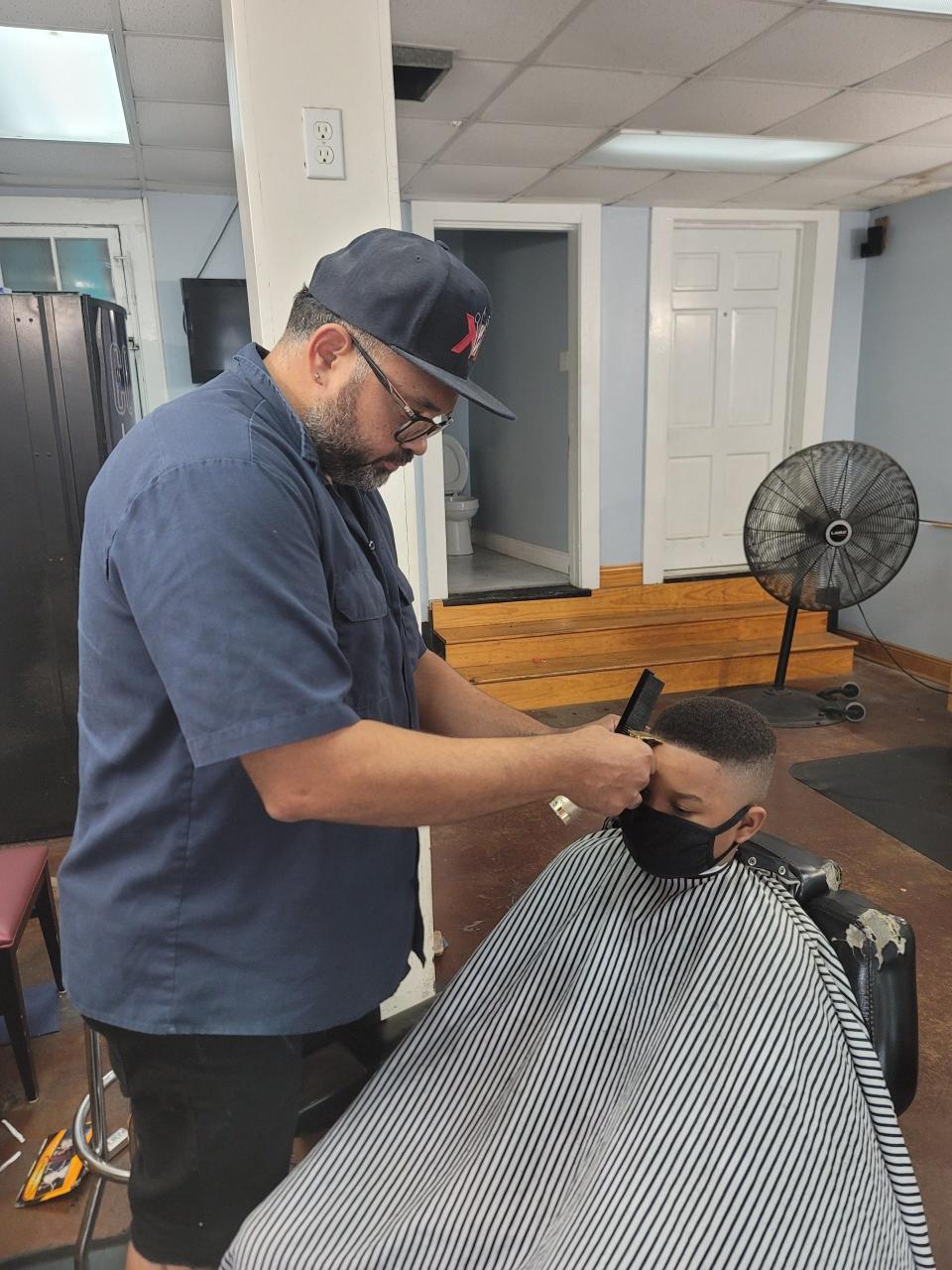 Taeyo Suarez cuts hair at his barbershop, Kutt Kreatorz, in New Orleans.