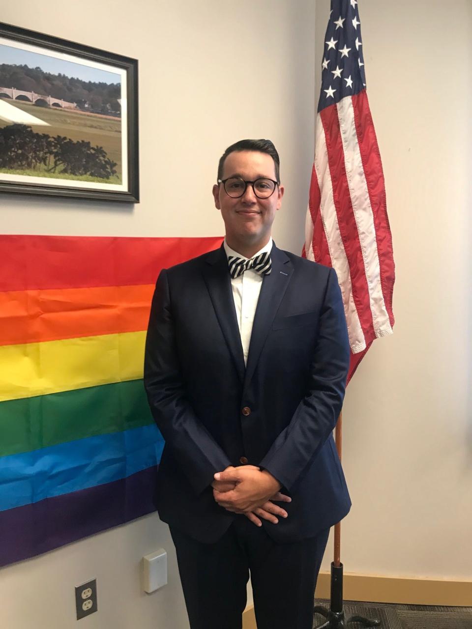 Former Dighton Selectman Brett Zografos stands in front of a rainbow flag on Aug. 25, 2021.