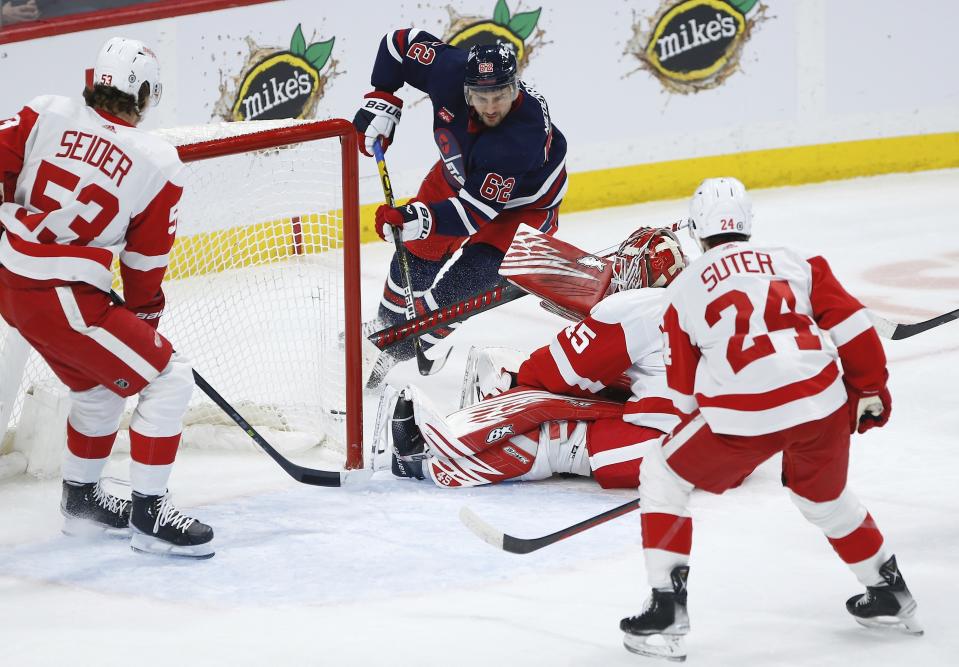 Detroit Red Wings goaltender Magnus Hellberg (45) saves a sho tby Winnipeg Jets' Nino Niederreiter (62) during first-period NHL hockey game action in Winnipeg, Manitoba, Friday, March 31, 2023. (John Woods/The Canadian Press via AP)