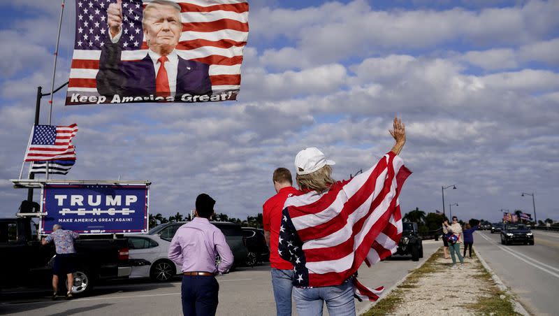 Evelyn Knapp, a supporter of former President Donald Trump, waves to passersby outside of Trump’s Mar-a-Lago estate on Monday, March 20, 2023, in Palm Beach, Fla.