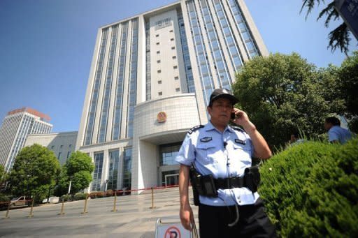 Security guards stand outside the Intermediate People's Court in Hefei, Anhui province on August 7. The wife of a former Chinese top politician at the heart of a scandal that has rocked the ruling Communist Party has admitted murdering a British businessman and blamed her actions on a "mental breakdown", state media reported Friday