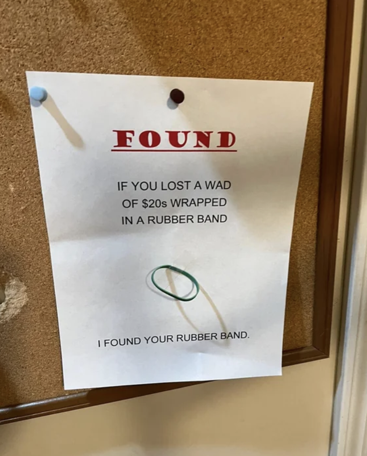 Sign saying "If you lost a wad of $20s wrapped in a rubber band, I found your rubber band," with a rubber band affixed to it