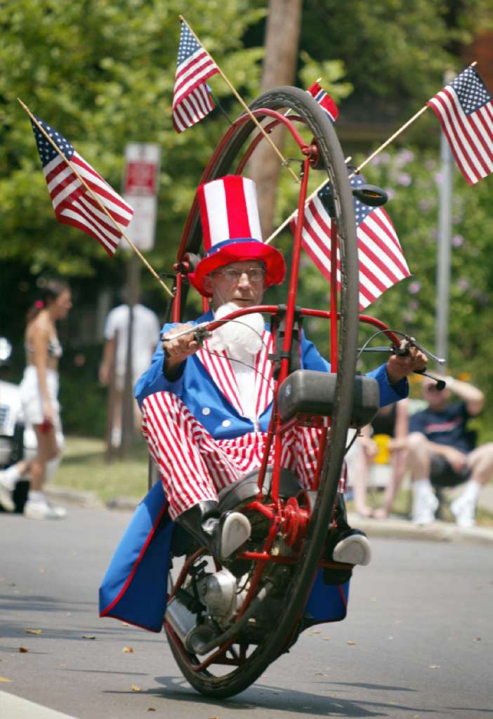 Keith Dufader, of Grandview, rides his hoop mobile down Neil Avenue during the Doo Dah parade on July 4, 2002.