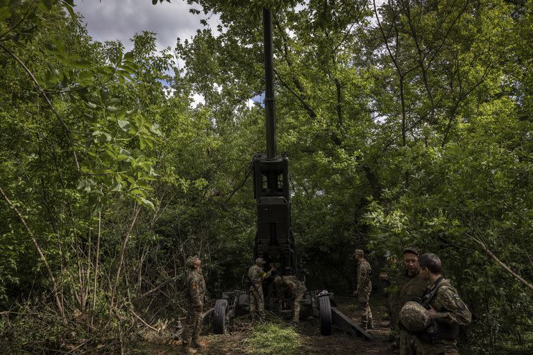 Los soldados ucranianos colocan un obús M777 en un grupo de árboles para camuflarse en la región de Donetsk, Ucrania, el domingo 22 de mayo de 2022. (Ivor Prickett/The New York Times)