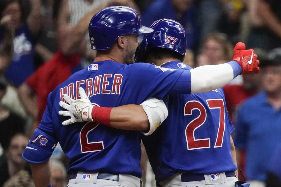 Chicago Cubs' Seiya Suzuki is congratulated by Nico Hoerner after hitting an inside-the-park home run during the ninth inning of a baseball game against the Milwaukee Brewers Monday, July 4, 2022, in Milwaukee. (AP Photo/Morry Gash)