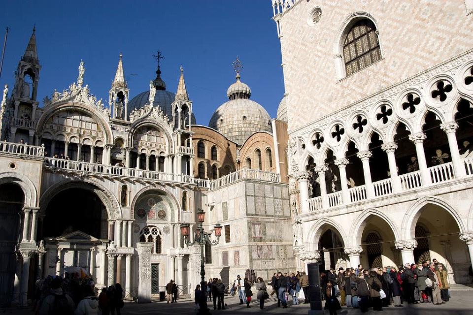 Tourists in front of the Saint Mark Basilica in Saint Mark Square in Venice, Italy.