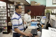 Prakash Patel, owner and pharmacist, foreground, works at Bert's Pharmacy in Elizabeth, N.J., on May 21, 2024. (AP Photo/Shelby Lum)