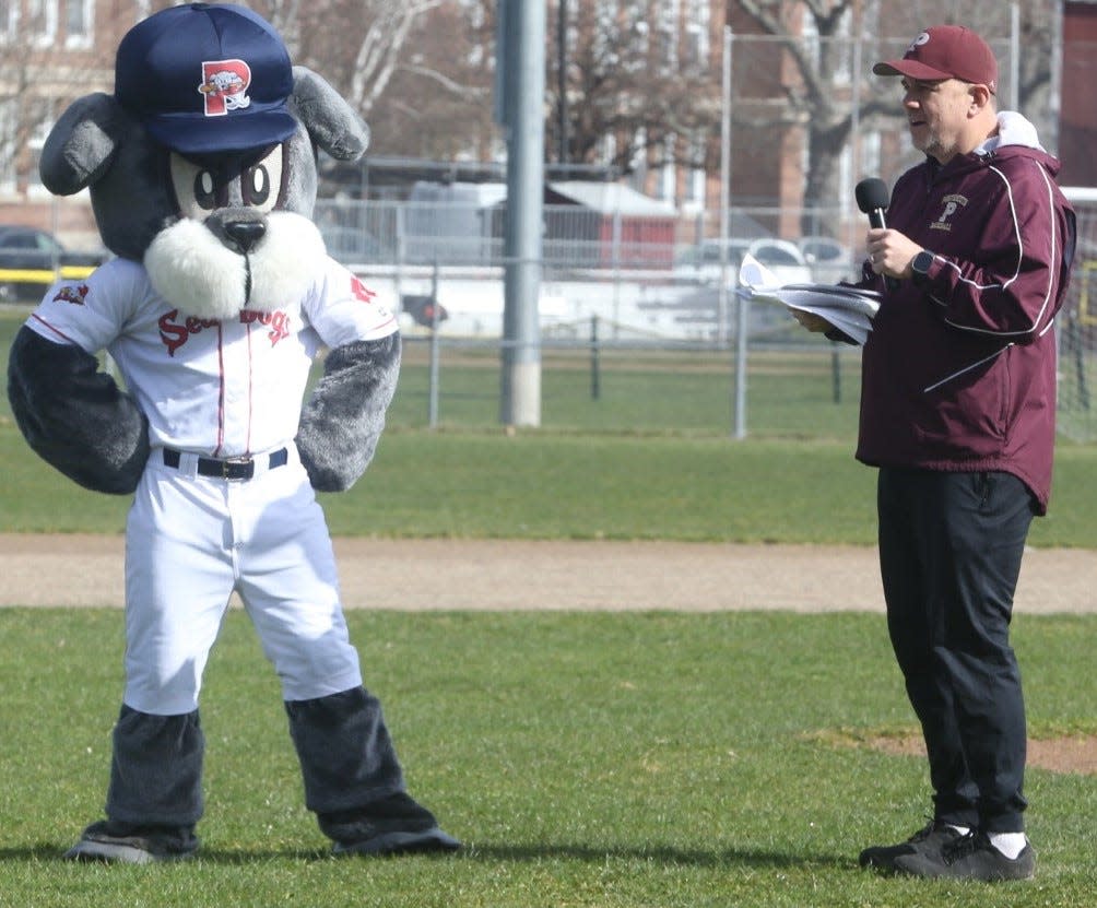 "Slugger," the mascot of the Portland Sea Dogs listens to Portsmouth Little League president Nik Uhlir during Saturday's Opening Day ceremonies at Leary Field.