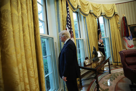 FILE PHOTO: U.S. President Donald Trump looks out a window of the Oval Office following an interview with Reuters at the White House in Washington, U.S., April 27, 2017. REUTERS/Carlos Barria