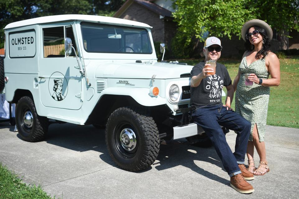 Owners of Olmsted Bev Co. Chas and Jen Olmsted, pose for a photo next to their 1967 Toyota Land Cruiser, which serves as a mobile beverage vehicle, in Maryville, Tuesday, July 5, 2022. Olmsted Bev Co. is a mobile beverage company, serving beverages on tap from unique vehicles.