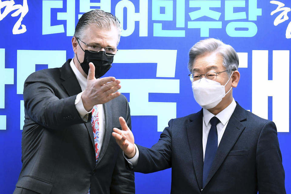 U.S. assistant Secretary of State for East Asian and Pacific Affairs Daniel J. Kritenbrink, left, gestures with South Korean Presidential candidate Lee Jae-myung at the ruling Democratic Party headquarters in Seoul, South Korea, Thursday, Nov. 11, 2021. Kritenbrink arrived in South Korea on Wednesday on the second leg of his two-stop Asia trip and will meet with senior government officials. (Kim Min-hee/Pool Photo via AP)