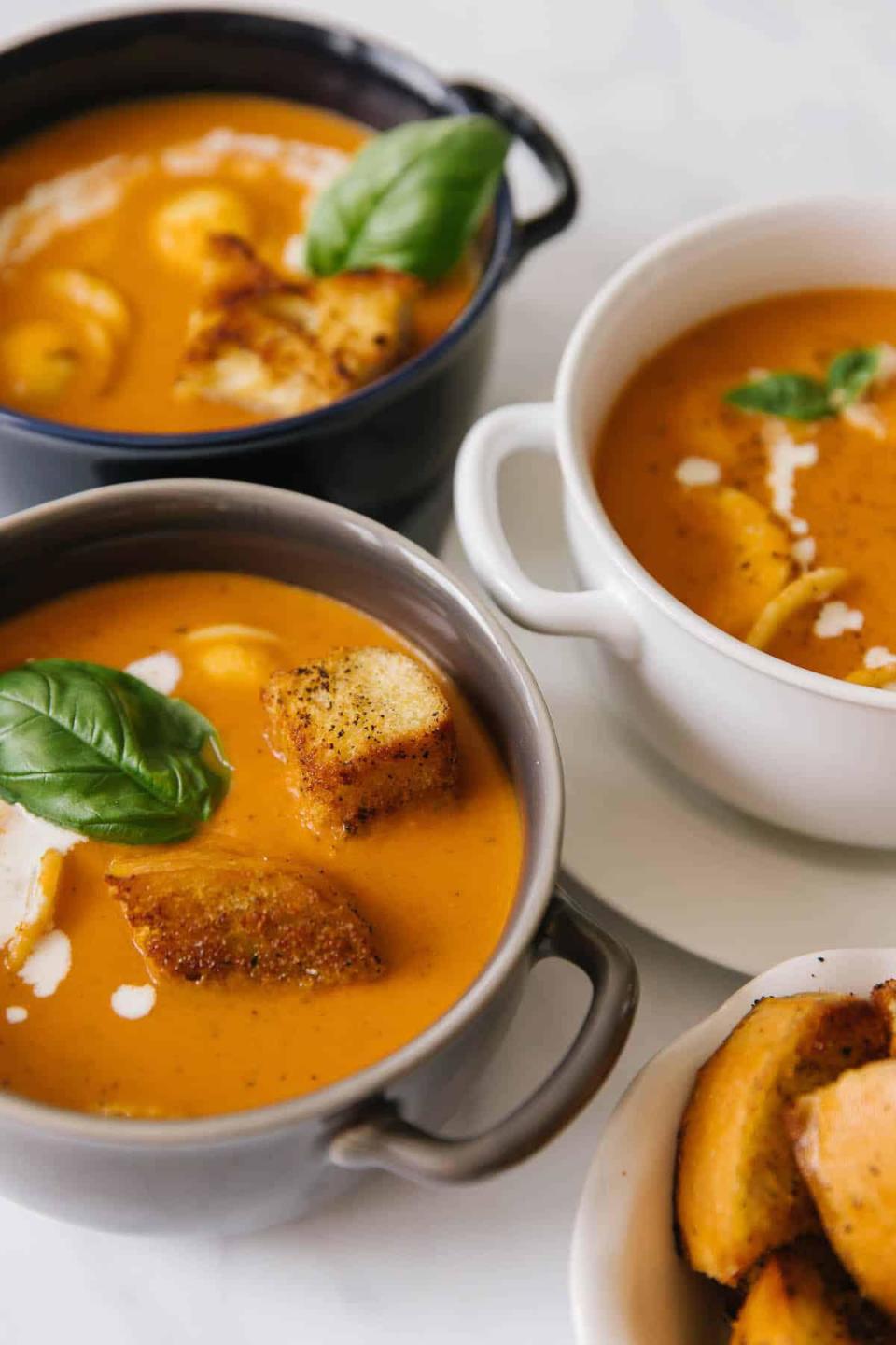 <p>One of the best ways to combat cold weather is to eat a warm bowl of soup. This creamy tomato basil soup is the perfect comfort food you need to <a href="https://www.thedailymeal.com/best-recipes/15-soups-and-stews-will-keep-you-warm-winter-slideshow?referrer=yahoo&category=beauty_food&include_utm=1&utm_medium=referral&utm_source=yahoo&utm_campaign=feed" rel="nofollow noopener" target="_blank" data-ylk="slk:warm you up;elm:context_link;itc:0;sec:content-canvas" class="link ">warm you up</a>. Add the soup’s ingredients to a slow cooker and let it do the cooking for you.</p> <p><a href="https://www.thedailymeal.com/best-recipes/tomato-basil-soup-freezer-homecooked-recipe?referrer=yahoo&category=beauty_food&include_utm=1&utm_medium=referral&utm_source=yahoo&utm_campaign=feed" rel="nofollow noopener" target="_blank" data-ylk="slk:For the Creamy Tomato Basil Soup recipe, click here.;elm:context_link;itc:0;sec:content-canvas" class="link ">For the Creamy Tomato Basil Soup recipe, click here.</a></p>