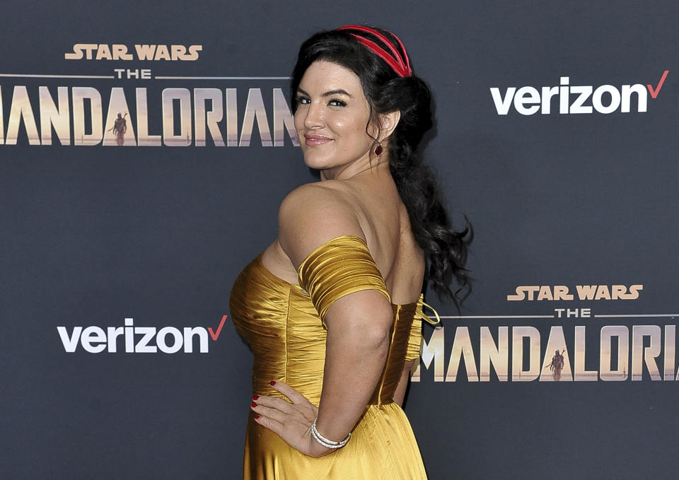 FILE - In this Wednesday, Nov. 13, 2019, file photo, Gina Carano attends the LA premiere of "The Mandalorian" at the El Capitan Theatre in Los Angeles. In a statement Wednesday, Feb. 10, 2021, Lucasfilm said Carano is no longer a part of “The Mandalorian” cast after many online called for her firing over a social media post that likened the experience of Jews during the Holocaust to the U.S. political climate. (Photo by Richard Shotwell/Invision/AP, File)