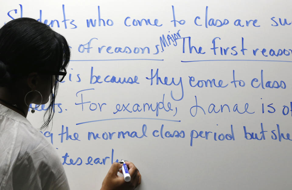 This photo gtaken March 12, 2014, shows developmental reading professor Naesea Price teaching a lesson on sentence and paragraph structure in a remedial English course at Baltimore City Community College in Baltimore. Only about a quarter of students nationally who take developmental _ or remedial _ classes ever graduate. The problem is so profound that the advocacy group Complete College America dubs remedial classes the “bridge to nowhere.” The challenge, educators say, is that even as billions is spent annually on remedial classes, many of these students run out of financial aid before they can complete their credit requirements, get discouraged by non-credit classes or find themselves unable to complete them. The Baltimore school is one of several places around the country looking to improve the odds for these students. (AP Photo/Patrick Semansky)