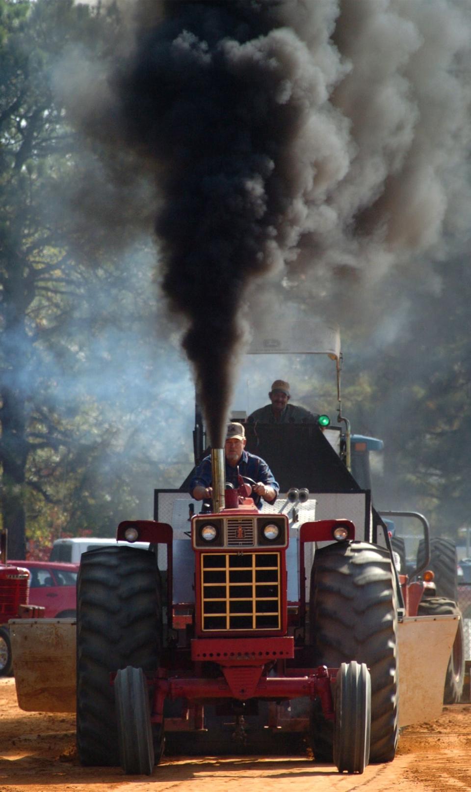 Johnny Hubbard of Fayetteville drives his International 1066 named "River Rat" in the tractor pull on Oct. 23, 2004, at Ole Mill Days in Hope Mills. The annual festival was canceled this year due to budgetary constraints.