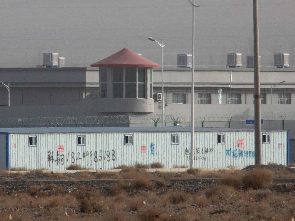 A guard tower and barbed wire fences are seen around a facility in the Kunshan Industrial Park in Artux in western China's Xinjiang region: AP