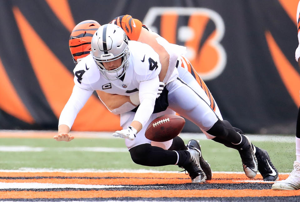 <p>Derek Carr #4 of the Oakland Raiders fumbles the ball as he is sacked by Sam Hubbard #94 of the Cincinnati Bengals at Paul Brown Stadium on December 16, 2018 in Cincinnati, Ohio. (Photo by Andy Lyons/Getty Images) </p>