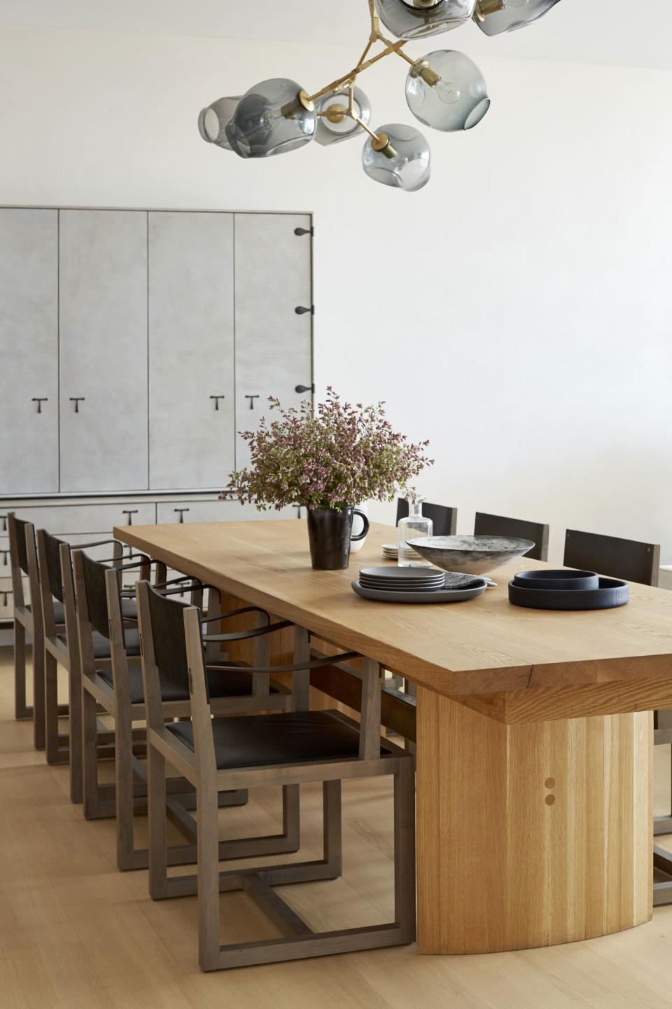 The living room flows right into the dining area, creating a central space where the family of five spends most of their time. A glass bubble chandelier hangs above the custom dining table, which is flanked by oxidized maple-and-leather chairs from BBDW. “We have dinner at the table together as a family most nights—it’s not just for Thanksgiving or entertaining,” says the owner.