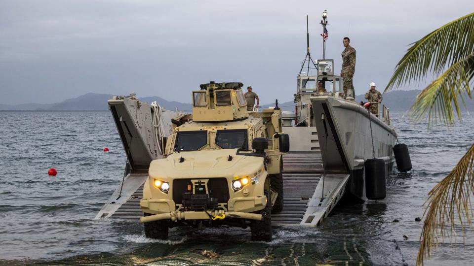 A U.S. Marine drives a Joint Light Tactical Vehicle off of an Army landing craft mechanized in preparation for the Balikatan drills at Camp Agnew in Casiguran, Philippines, on April 8, 2023. (Staff Sgt. Danny Gonzalez/U.S. Marine Corps)