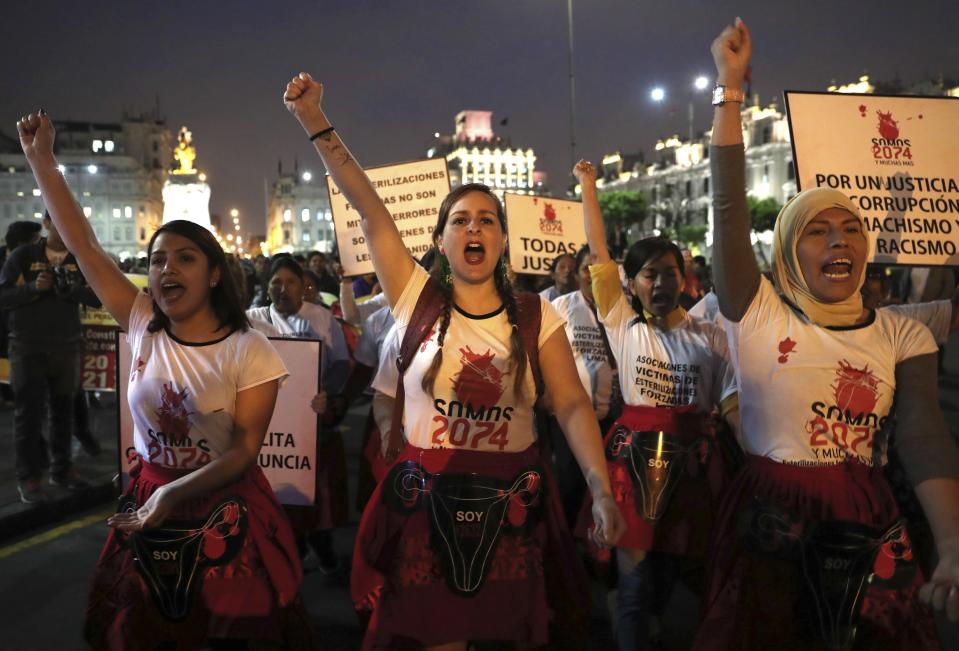Demonstrators depicting female victims of forced sterilization during Alberto Fujimori's government, perform during a protest in Lima, Peru, Wednesday, Oct. 17, 2018. Hundreds marched in Lima's downtown to protest against government corruption. An appeals judge has freed Peru's opposition leader Keiko Fujimori a week after she was arrested during a money laundering investigation. (AP Photo/Martin Mejia)