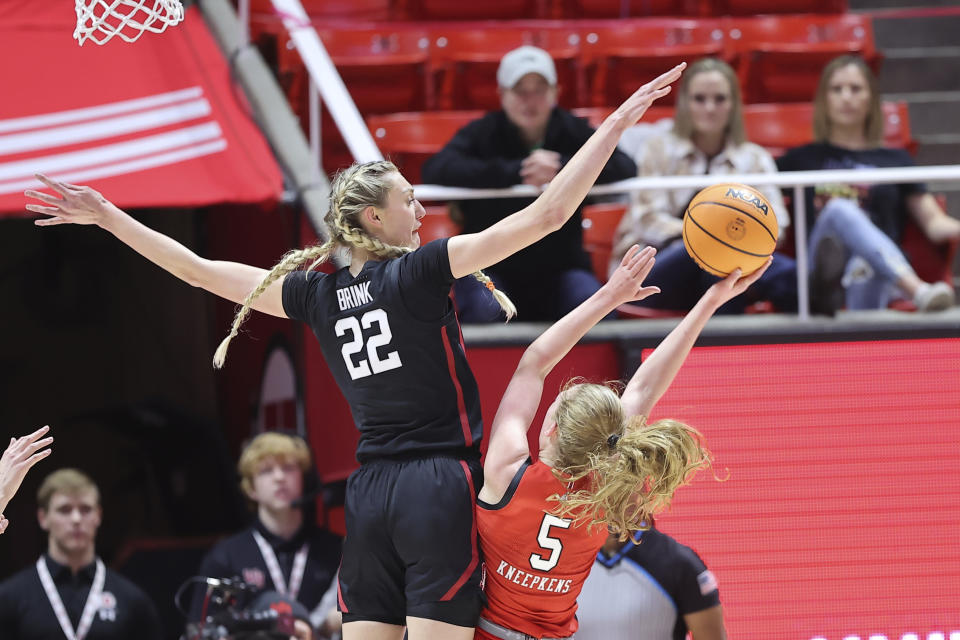 Stanford forward Cameron Brink (22) blocks the shot of Utah guard Gianna Kneepkens (5) in the first half of an NCAA college basketball game Saturday, Feb. 25, 2023, in Salt Lake City. (AP Photo/Rob Gray)