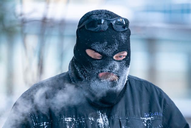 Charles Zajicek uses a power sweeper to clear snow off the sidewalk Thursday in downtown Minneapolis. The Twin Cities saw 8 inches of snow Wednesday.