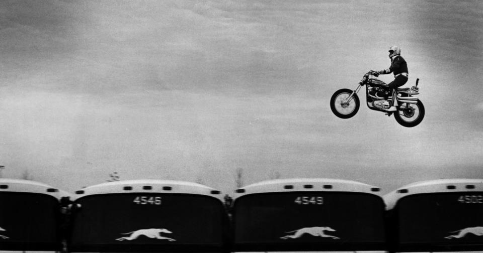 Evel Knievel soars over 14 Greyhound buses in the longest jump of his career.