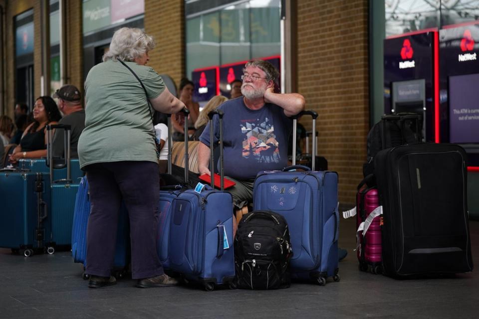 Passengers waiting at King’s Cross station in London (Yui Mok/PA) (PA Wire)