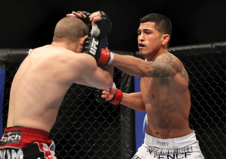 SAITAMA, JAPAN - FEBRUARY 26: (R-L) Anthony Pettis punches Joe Lauzon during the UFC 144 event at Saitama Super Arena on February 26, 2012 in Saitama, Japan.