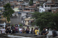 Relatives of Emily Victoria Silva dos Santos, 4, and Rebeca Beatriz Rodrigues dos Santos, 7, attend their burial at a cemetery in Duque de Caxias, Rio de Janeiro state, Brazil, Saturday, Dec. 5, 2020. Grieving families held funerals for Emily and Rebeca, killed by bullets while playing outside their homes. Weeping and cries of “justice” were heard Saturday at their funerals, reflecting the families’ assertion that the children were killed by police bullets. (AP Photo/Silvia Izquierdo)