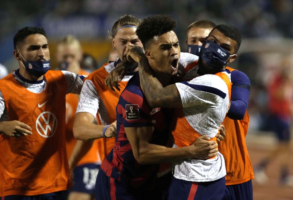 United States's Antonee Robinson, center, celebrates with his teammates after scoring his side's opening goal against Honduras during a qualifying soccer match for the FIFA World Cup Qatar 2022, in San Pedro Sula, Honduras, Wednesday, Sept. 8, 2021. (AP Photo/Moises Castillo)