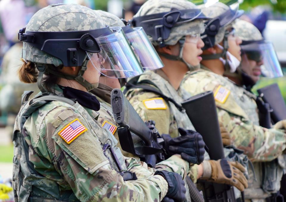 Minnesota State Police and National Guard keep watch after a night of riots and looting in Minneapolis. Protests continued across the nation Friday night.