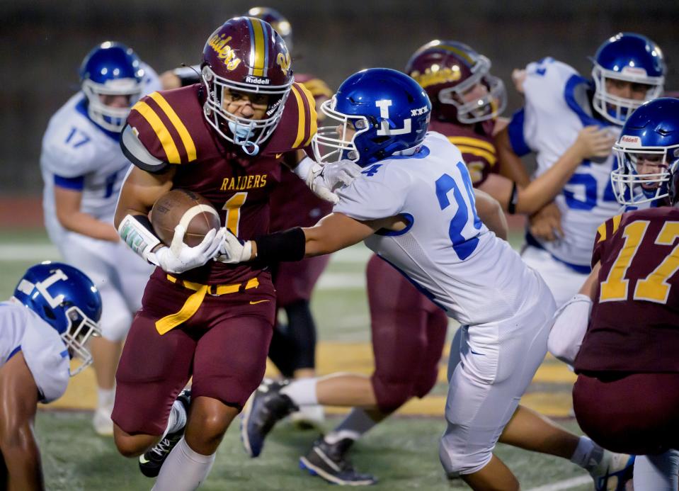 East Peoria's Gabriel Zeigler-Harris runs through the Limestone defense in the first half Friday, Sept. 9, 2022 in East Peoria. The Raiders defeated the Rockets 33-20.