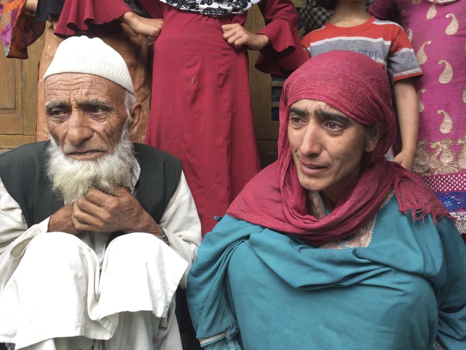 In this Monday, Aug. 26, photo, A Kashmiri man Mohammed Abdullah sits with his daughter at their home and talks to reporters about his grandson who was picked up in a nocturnal raid recently and shifted to a jail in India’s northern city of Agra, in southern Karimabad village, Indian controlled Kashmir. The main city of Indian-controlled Kashmir presents a mostly deserted and subdued look, woven in a maze of razor wire. But drive out into the rural hinterland and residents in village after village narrate horrors of regular nightly raids by Indian army soldiers. The abuses in the nighttime raids by troops began in early August as New Delhi took its action on Kashmir, according to interviews with at least 200 people. The change in status nullified decades-old constitutional provisions that gave Jammu and Kashmir some political autonomy and land inheritance rights. (AP Photo/Aijaz Hussain)