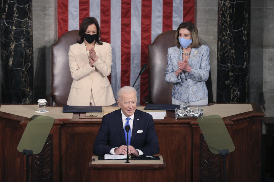 President Joe Biden arrives to address a joint session of Congress, Wednesday, April 28, 2021, in the House Chamber at the U.S. Capitol in Washington, as Vice President Kamala Harris, left, and House Speaker Nancy Pelosi of Calif., look on. (Chip Somodevilla/Pool via AP)