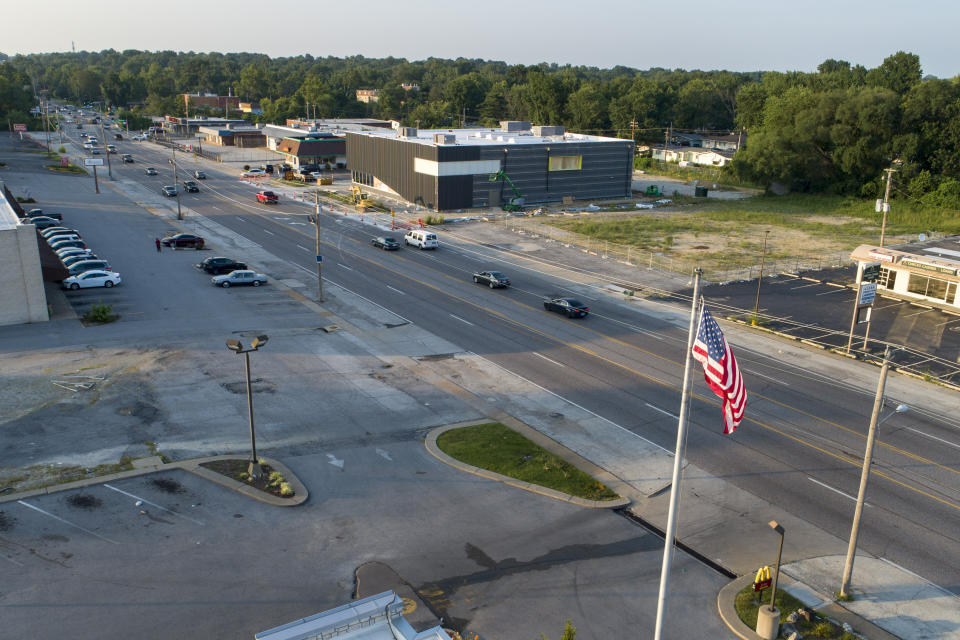 In this July 24, 2019, photo, cars move along West Florissant Avenue, the scene of nightly protests in the weeks following the shooting death of Michael Brown by a police officer in 2014, in Ferguson, Mo. The road is much quieter today. (AP Photo/Jeff Roberson)