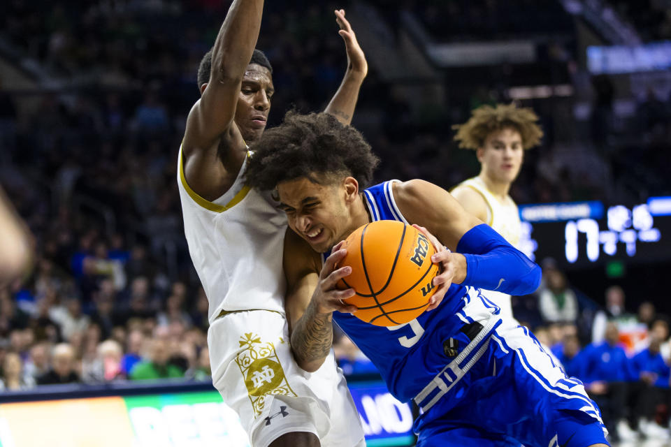 Duke's Tyrese Proctor (5) drives against Notre Dame's Markus Burton during the first half of an NCAA college basketball game Saturday, Jan. 6, 2024, in South Bend, Ind. (AP Photo/Michael Caterina)