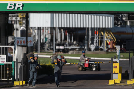Workers walk in front of the entrance of the Petrobras Alberto Pasqualini Refinery in Canoas, Brazil May 2, 2019. Picture taken May 2, 2019. REUTERS/Diego Vara