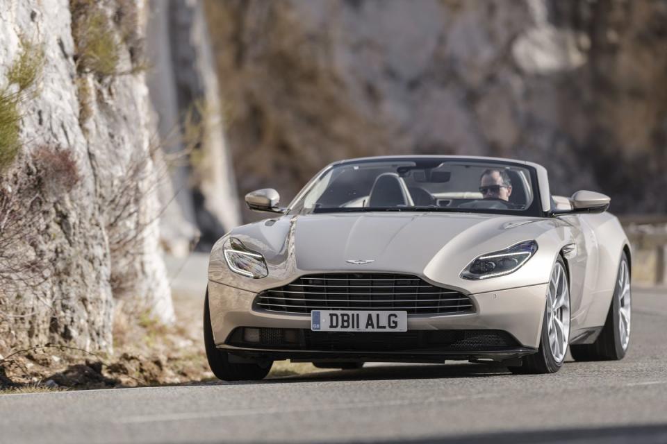 <p>Out on the road, the added mass feels inconsequential. The DB11 has dramatic proportions: At nearly 77 inches wide excluding the mirrors, the Aston is more than three inches wider than a Honda Accord. This makes for some exciting exercises in practical geometry-particularly in this region of France, where the roads get so narrow in places, you feel like you could palm both guardrails by simply stretching out your arms. The DB11’s broad shadow and 110-inch wheelbase make it feel sure-footed on sweepers and hairpins alike.</p><p><em>Continue reading our first drive review of the DB11 Volante <a href="https://www.roadandtrack.com/new-cars/first-drives/a18209860/2019-aston-martin-db11-volante-first-drive/" rel="nofollow noopener" target="_blank" data-ylk="slk:here;elm:context_link;itc:0;sec:content-canvas" class="link ">here</a>. </em></p>