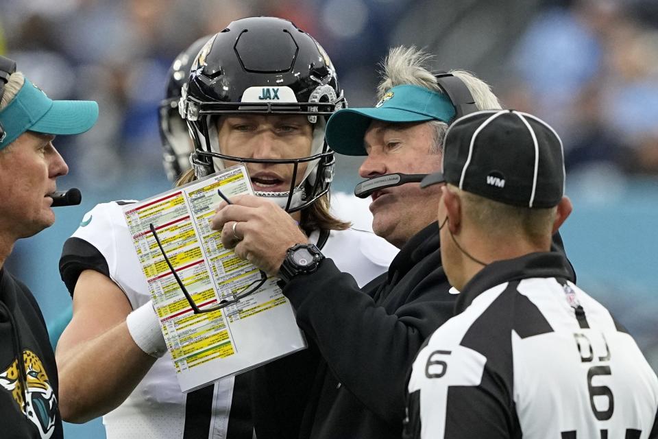 Jaguars coach Doug Pederson, center, seen talking with quarterback Trevor Lawrence during the Tennessee Titans game, doesn't want his team thinking "too far forward" about potentially being in the playoffs, but the fans should cherish every moment of being in the postseason hunt.