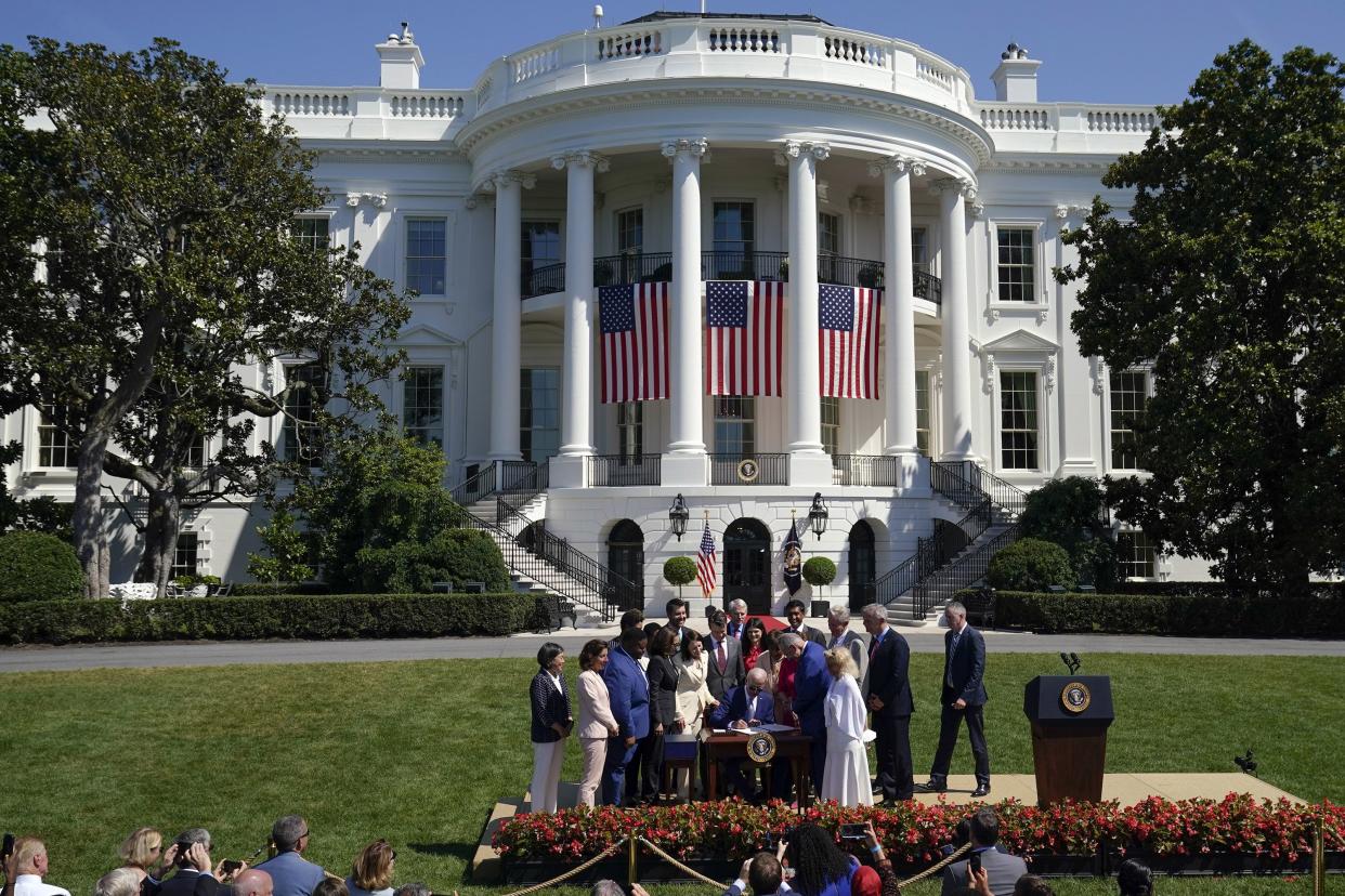 President Joe Biden signs the "CHIPS and Science Act of 2022" during a ceremony on the South Lawn of the White House on Tuesday, Aug. 9, 2022, in Washington.