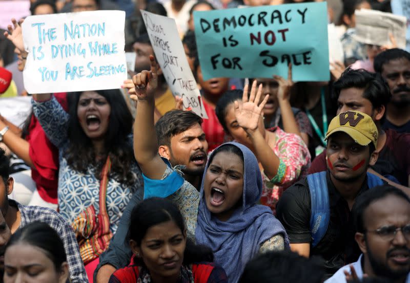 Students hold placards and shout slogans in solidarity with Jamia Millia Islamia university students, in Mumbai