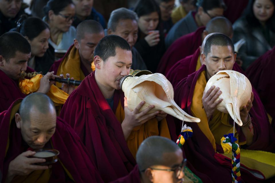 Exile Tibetan Buddhist monks blow ceremonial conch shells during an early morning prayer session to mark the first day of the Lunar New Year at the Tsuglakhang temple in Dharamshala, India, Saturday, Feb. 10, 2024. (AP Photo/Ashwini Bhatia)