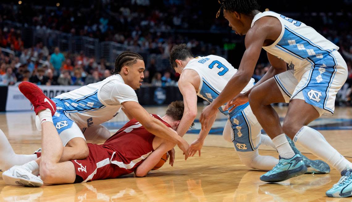 Alabama’s Grant Nelson (2) protect a loose ball from North Carolina’s Seth Trimble (7), Cormac Ryan (3) and Harrison Ingram (55) in the second half during the NCAA Sweet Sixteen on Thursday, March 28, 2024 at Crypto.com Arena in Los Angeles, CA.