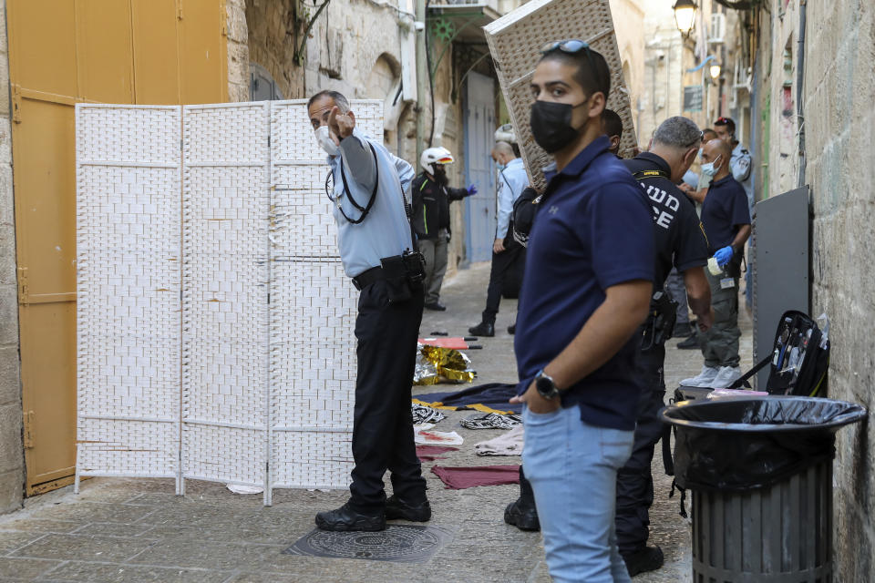Israeli police examine the scene of a stabbing attack in Jerusalem's Old City, Thursday, Sept. 30, 2021. Israeli police say an alleged Palestinian attacker has been shot and killed after a stabbing attack in Jerusalem's Old City. (AP Photo/Mahmoud Illean)
