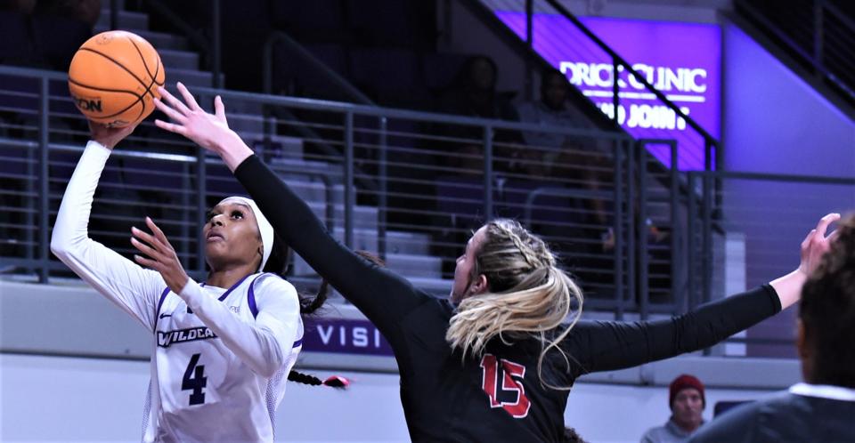 ACU's Maleeah Langstaff, left, drives to the basket as Southern Utah's Lizzy Williamson defends in the first quarter.