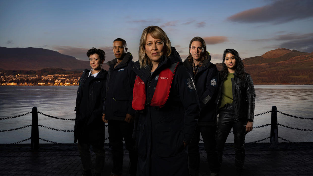  Annika season 2: A composite shot of the cast of Annika's second season, standing in front of a waterfront view. From left to right: Katie Leung as DC Blair Ferguson, Ukweli Roach as DS Tyrone Clarke, Nicola Walker as DI Annika Strandhed, Jamie Sives as DS Michael McAndrews, Varada Sethu as DC Harper  