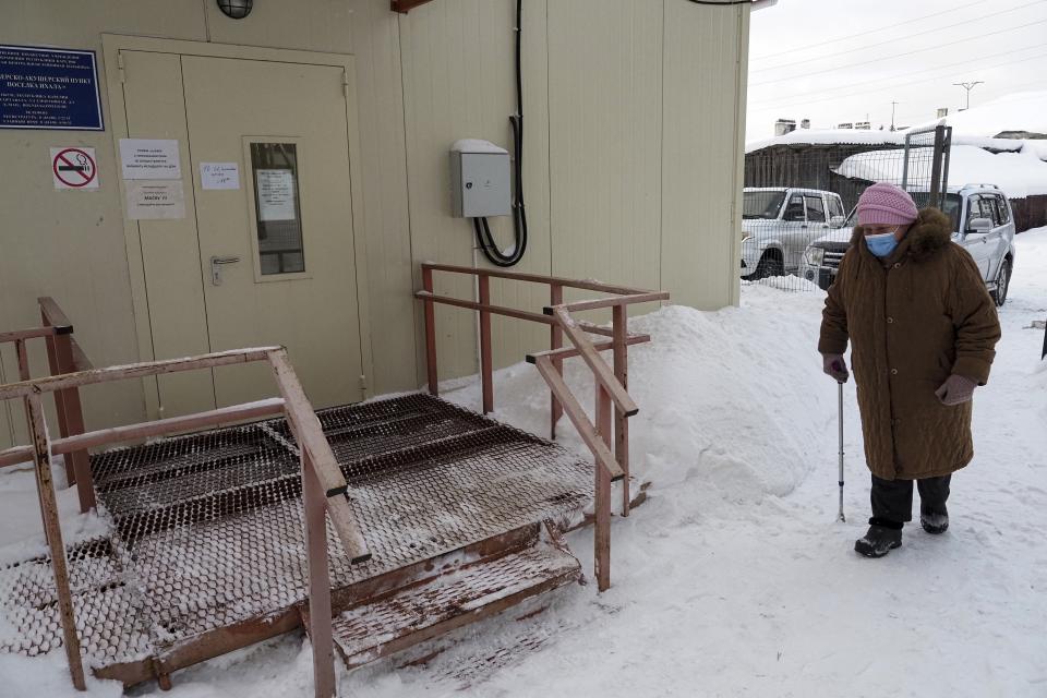 An elderly woman walks to a local rural medical post to get a Sputnik V vaccine in the village of Ikhala in Russia’s Karelia region, Tuesday, Feb. 16, 2021. Russia’s rollout of its coronavirus vaccine is only now picking up speed in some of its more remote regions, although experts say the campaign is still moving slowly. (AP Photo/Dmitri Lovetsky)