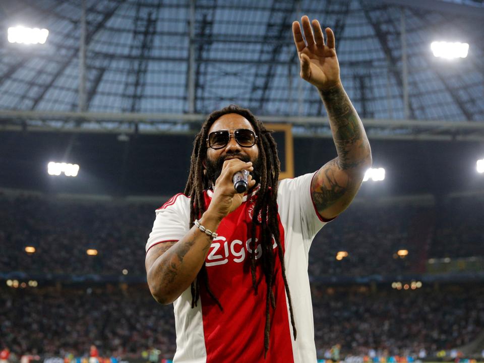 Ky-Mani Marley sings on the pitch at half time during a match of the UEFA Champions League between Ajax and AEK Athens on September 19, 2018 in Amsterdam, Netherlands.