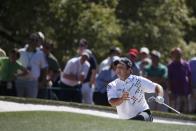 U.S. golfer Patrick Reed climbs out of the bunker after his shot on the first hole during the first round of the Masters golf tournament at the Augusta National Golf Club in Augusta, Georgia April 10, 2014. REUTERS/Mike Segar (UNITED STATES - Tags: SPORT GOLF)